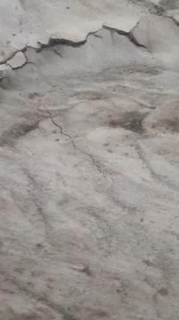 Wet Mud and Eroded Clay Ground Surface Texture Stock Photos
