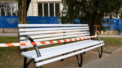 Wet paint white bench with red and white fencing tape Vídeos de archivo 113742849