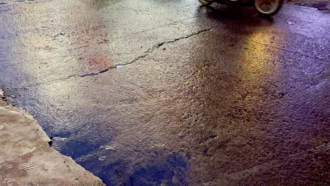 Wet pavement reflecting warm light after rain Stock Footage 335430513