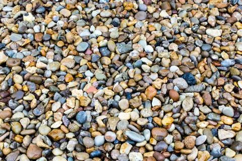 Wet peebles at a river basin Stock Photos