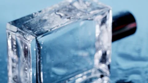 Wet perfume on blue rotating  camera Stock Footage 256651486