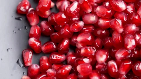 Wet pomegranate seeds. Red arils with water droplets Видео 332171996