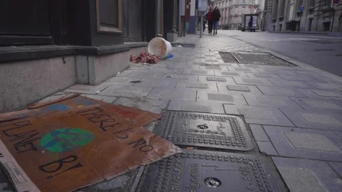 Wet poster on the ground with There is no planet B. Bucket of meat in the Vídeos de archivo 128821829