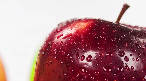 Wet red apple isolated on white background, close up rotation. Stock Footage 63395078