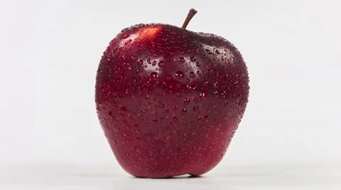 Wet red apple isolated on white background, close-up rotation. 스톡 동영상 63507619
