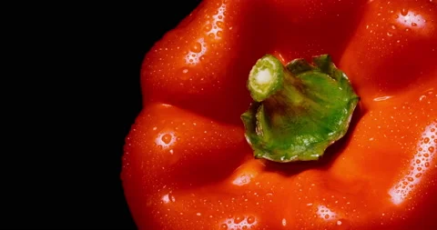 Wet red bell pepper rotates on black background. Macro. Stock Footage 154428544