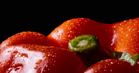 Wet red bell pepper rotates on black background. Macro. Stock Footage 154429501