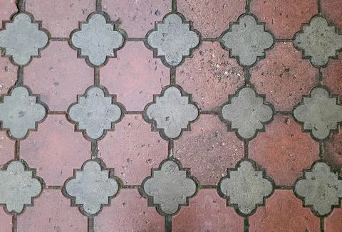 Wet red patterned paving slabs. Outdoor tile background. Stock Photos