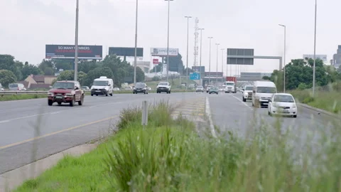 Wet Roadside Verge Beside Multi Lane Joburg Commuter Route 스톡 동영상 345025574