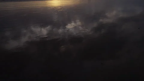 Wet sand reflecting sunset sky by ocean on Bali island Stock Footage 314683146