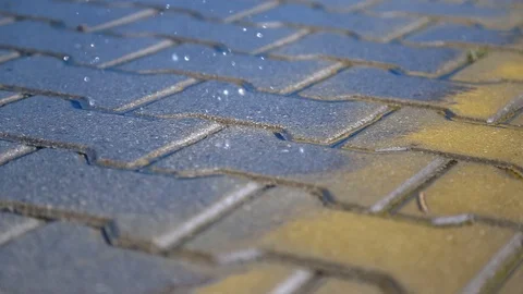 Wet sidewalk in the rain. rain drops fall on the pavement Видео 125659436