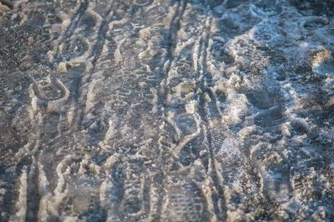 Wet slush and melting ice with dirty snow creating a textured surface on the  Stock-Fotos