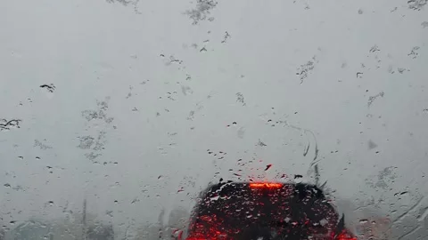 Wet snow falls on the windshield of a car and immediately melts Stock Footage 272310993