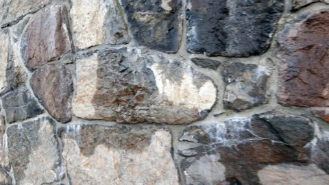 Wet stone wall made of large rocks and boulders - abstract background and Stock Footage 232282084