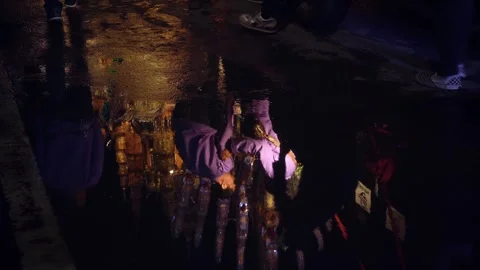 Wet street reflection of Thai parade float and crowd at Loy Krathong night Stock Footage 336220247