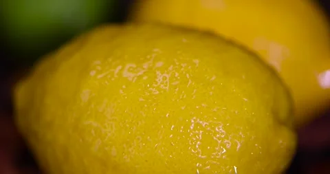 Wet sweet and sour lemon and green limes lying on the table, ripe citrus fruits Stock Footage 320374875