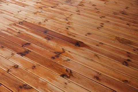 Wet timber deck close up with grooved planks, grain and knots in rain Stock Photos