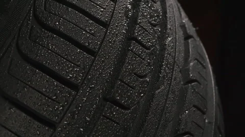 Wet Tire Protector on a Black Background 4K Stock Footage 333008680