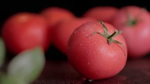 Wet tomato on a black background Stock Footage 156258922