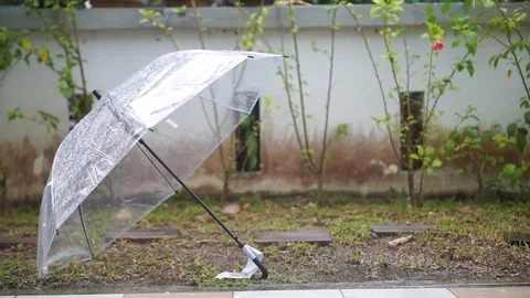 A wet umbrella in the rain Stock Footage 105055267