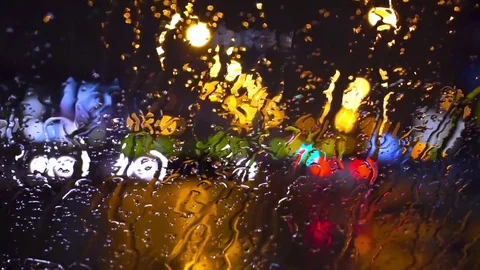 Wet the window with the background of the night city traffic view Stock Footage 70269646
