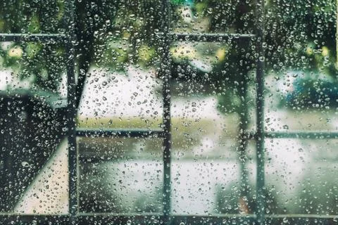 Wet window in drops during the summer rain Stock Photos