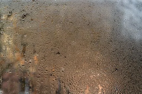 Wet window features vertical water lines cutting through mist layer. Glass .. 스톡 사진
