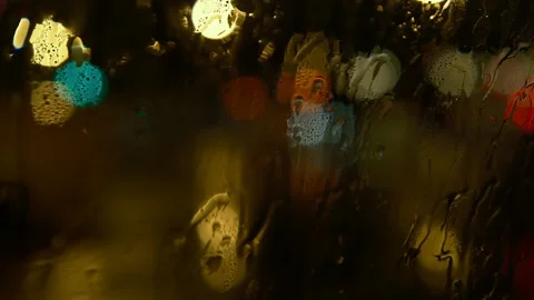 Wet window inside in car, defocused traffic jam on highway rainy night Stock-Footage 295452144