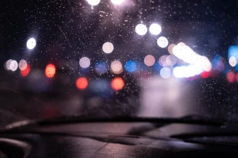 Wet window texture with blurry lights at night Stock Photos