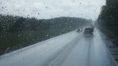 The Wet Windshield Of The Bus. The Wipers Are Triggered. Cloudy Weather. Stock Footage 182299792