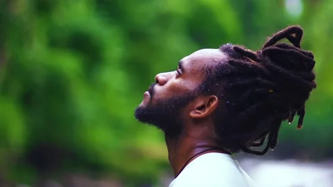A Wet Young Man Dreadlocks Staring at the Sky in The Nature Stock Footage 209172184