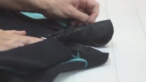Wetsuit Donning. close up hands Slowly push zipper adjust the neck seal. Water 스톡 동영상 313649904