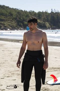 Wetsuit pulled down after a good surf and relaxing Stock Photos