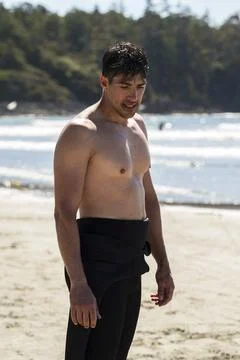 Wetsuit pulled down after a good surf and relaxing Stock Photos