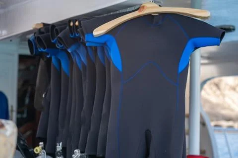 Wetsuits Hanging on Display for Diving Activities at a Marine Location Duri.. Stock Photos