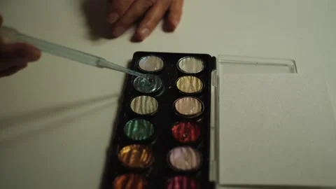 Wetting the glitter paint. paint in the palette Close up Stock Footage 158572946