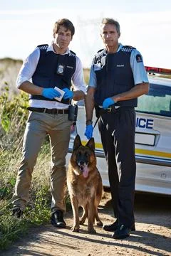 Weve brought our best detective. Full length portrait of two policemen and their Stock Photos