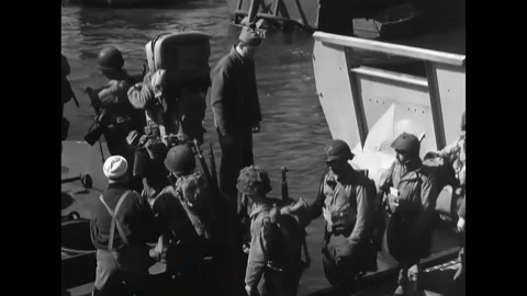 WEYMOUTH - 1944 - Troops board a ship at a dock and board a landing craft with Video stock 312793987
