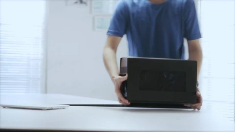WFH Day 52-an Asian young man unpack an external GPU device Video stock 129727651