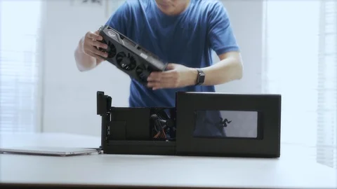 WFH DAY 53 -a young Asian man assembling an external GPU device Video stock 129727686