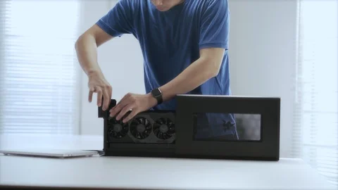 WFH Day 54-a young Asian man assembling an external GPU device Stock Footage 129727862