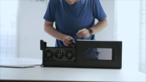 WFH Day 55-a young Asian man assembling an external GPU device Video stock 129727797