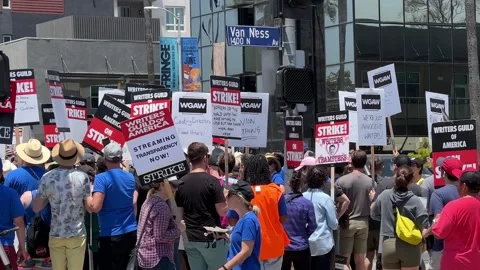 WGA writers on strike picket in front of Netflix Stock Footage 244881982