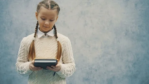 What can be better for smart inquisitive girl than new books Stock Footage 113067879