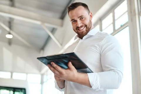 What can we do to get you in a car. a car salesman writing on a clipboard. Stock Photos