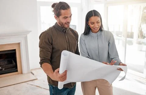 What can we do with this. two young architects looking at building plans on site Fotos de archivo