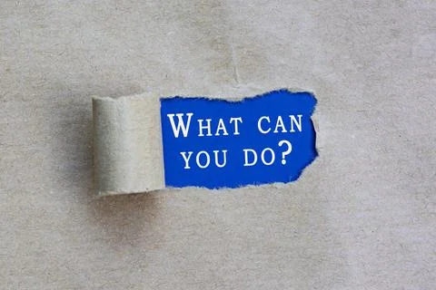 What can you do text on torn hole in the sheet of brown paper on blue backgro Foto stock