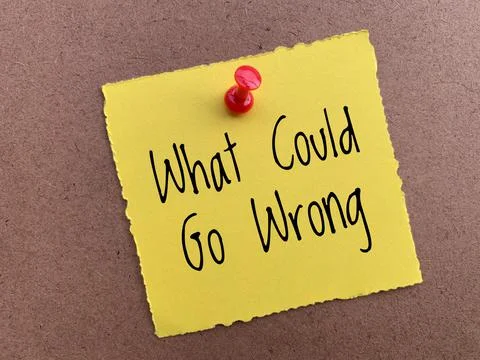 What could go wrong text on yellow torn notepad. Conceptual. Stock Photos