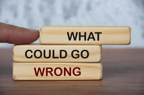 What could go wrong text on wooden blocks with blurred marble background. Foto stock