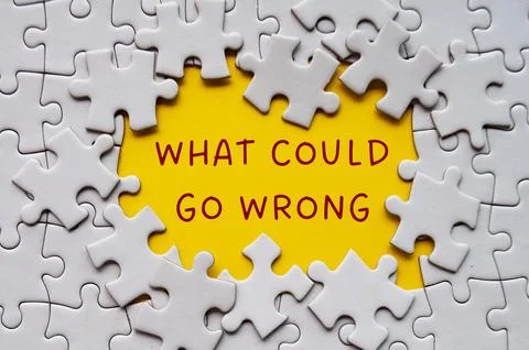 What could go wrong text on missing jigsaw puzzle. Solution concept Stock Photos
